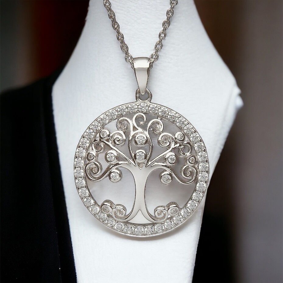 Sterling silver Tree of Life pendant with sparkling clear CZ stones, handcrafted Celtic jewelry shown on jewelry holder.