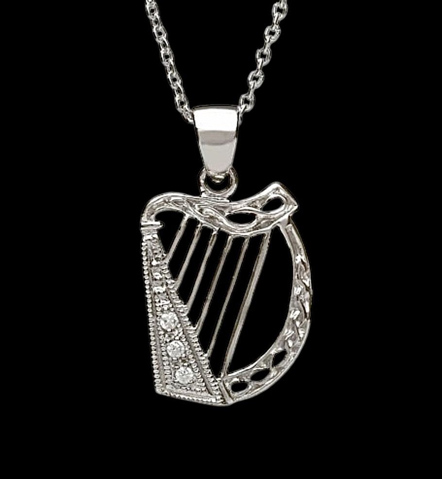Celtic harp sterling silver pendant with CZ stones, traditional Irish jewelry and cultural symbol, shown on black background.