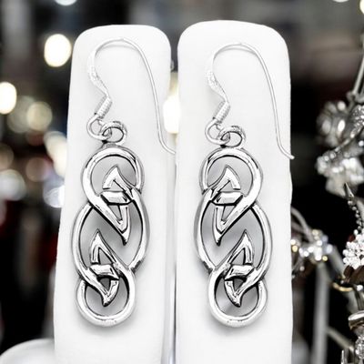 Sterling silver Celtic knot weave earrings celebrating timeless Celtic symbolism and heritage. Shown on earrings holder. 