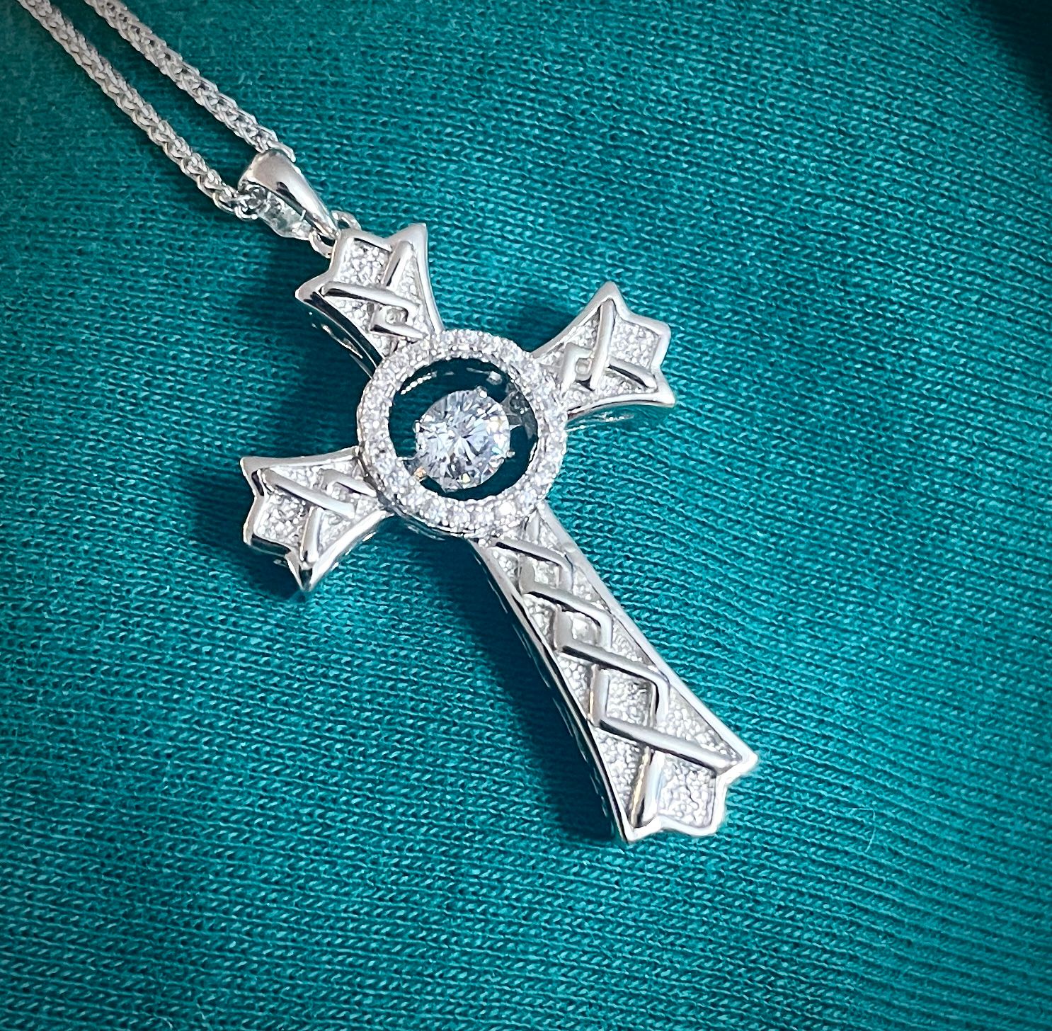 High-quality sterling silver cross necklace featuring Celtic knot design and sparkling central CZ stone, perfect gift. 