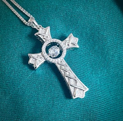 High-quality sterling silver cross necklace featuring Celtic knot design and sparkling central CZ stone, perfect gift. 