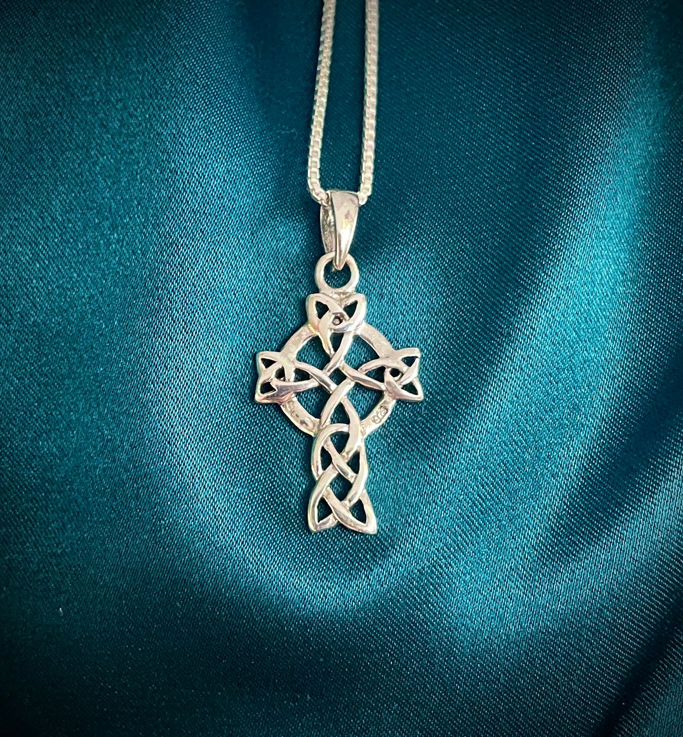 Sterling silver Celtic cross pendant with trinity knots, detailed Celtic knot design, meaningful heritage jewelry. 