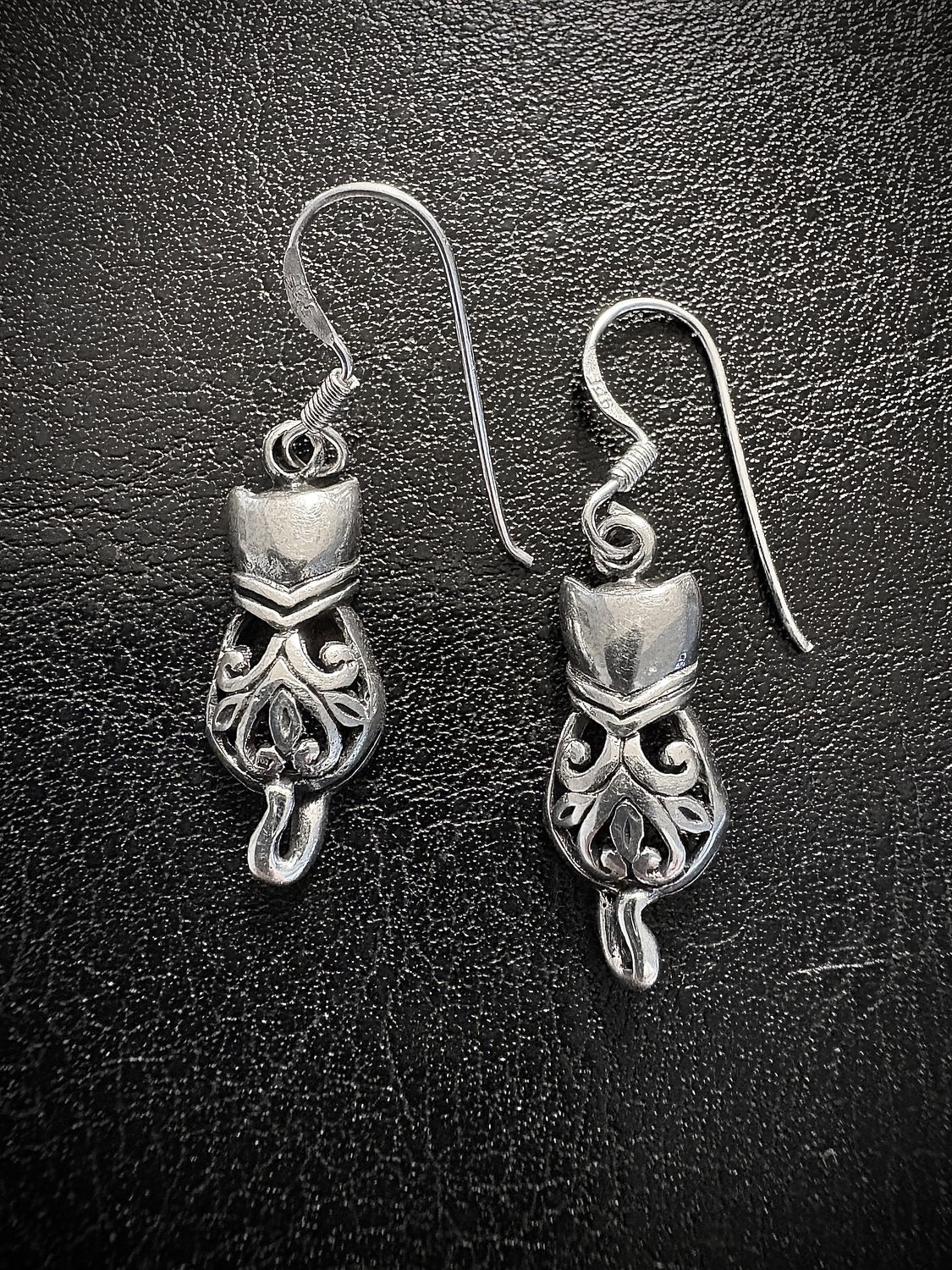 Sterling Silver Celtic Knot Cat Earrings on Black Background. 
