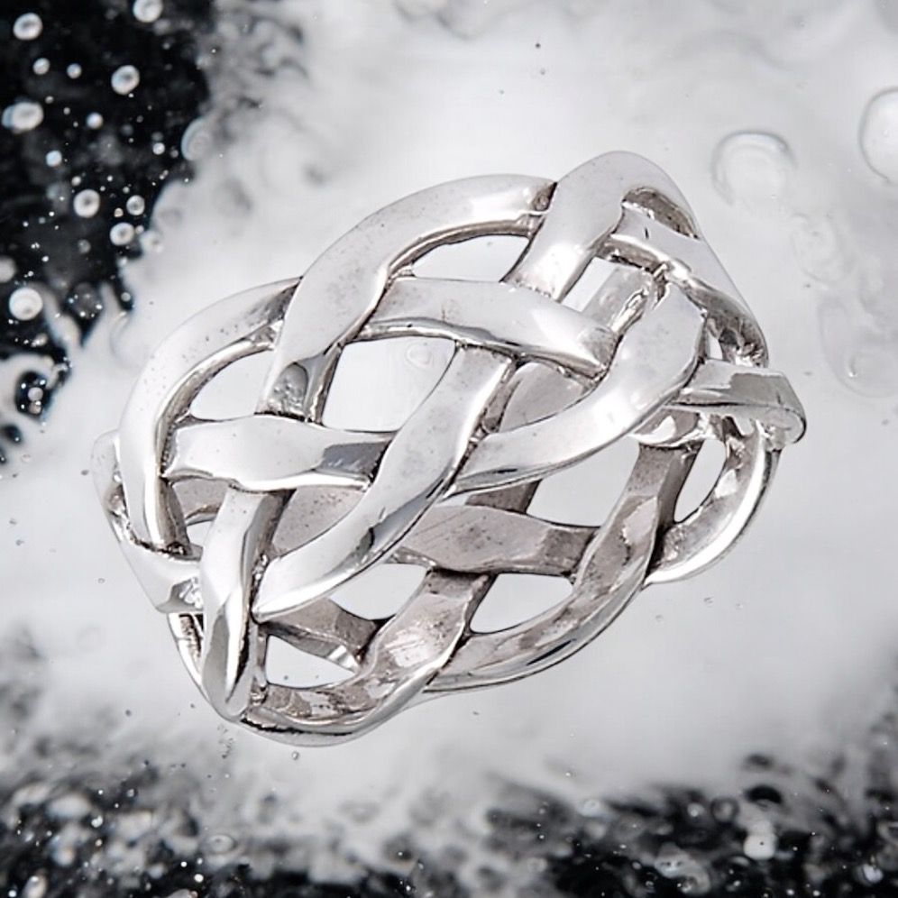 Sterling silver Celtic weave ring with intricate knotwork, elegant and inspired by Celtic heritage. On Water background. 